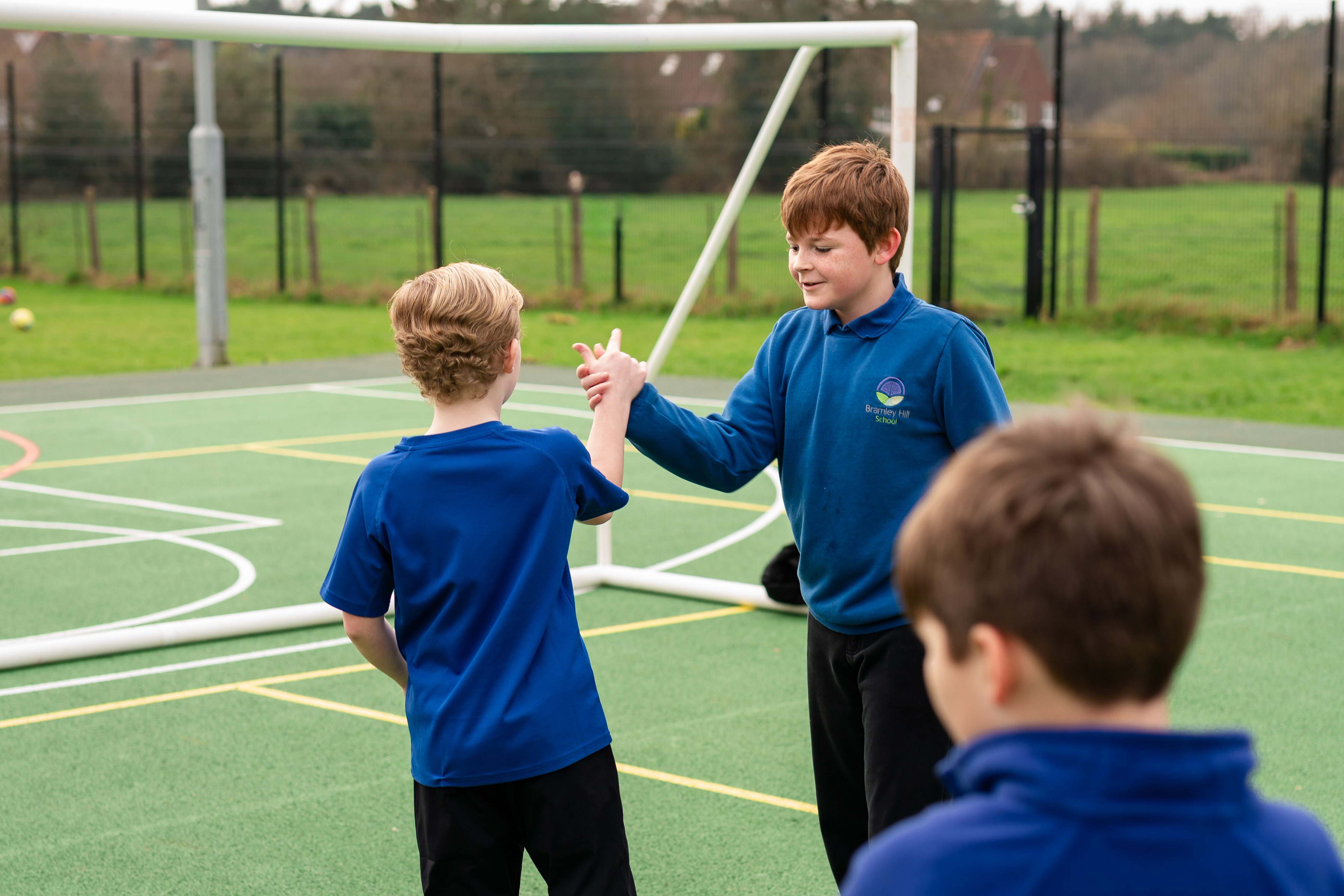 Children from Bramley Hill School playing on football court