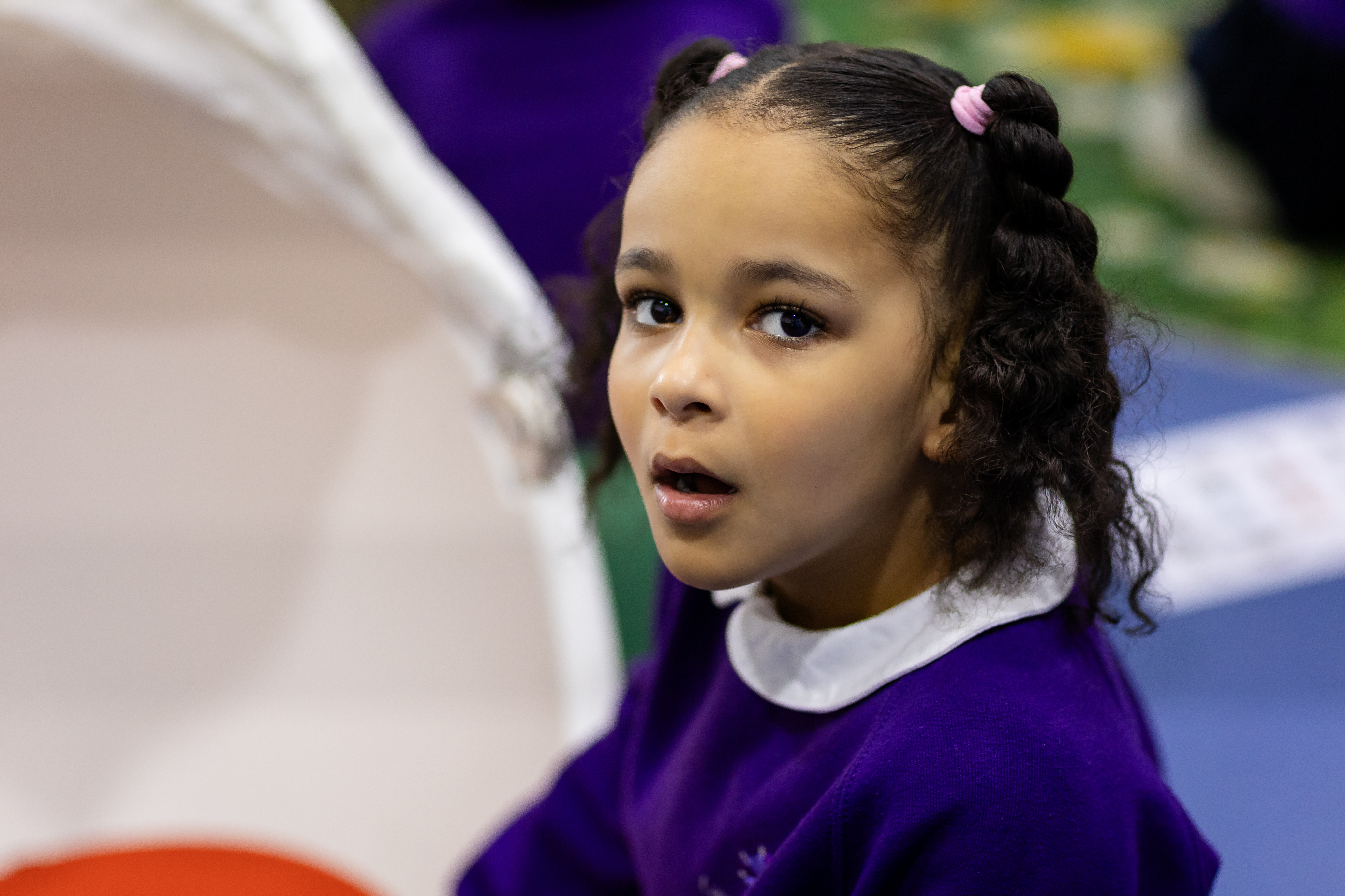 Young girl from Lavender Lodge School with dark hair and purple jumper smiling