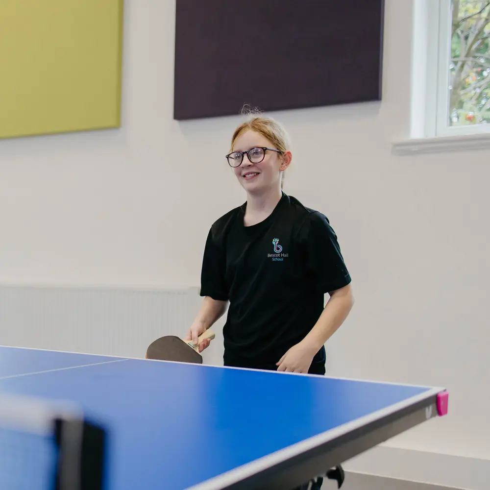 A young girl at Bescot Hall School playing ping pong