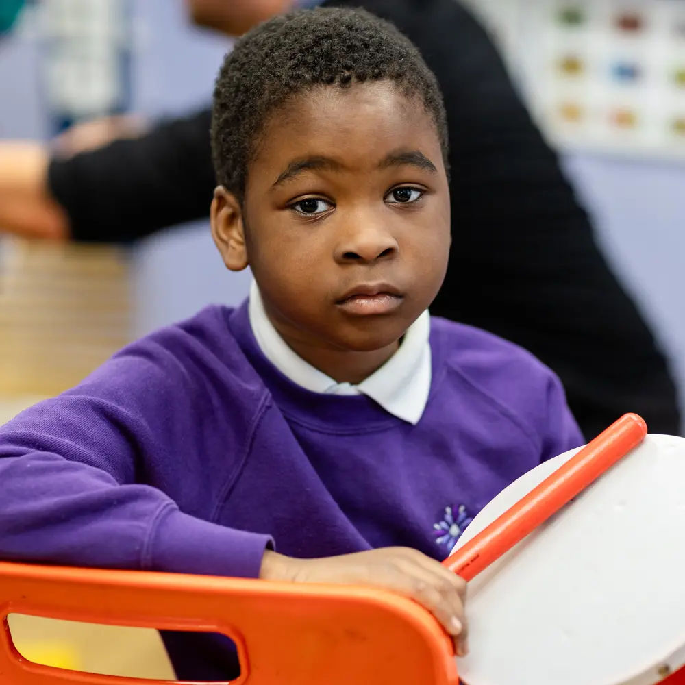 A young boy from Lavender Lodge School looking at the camera