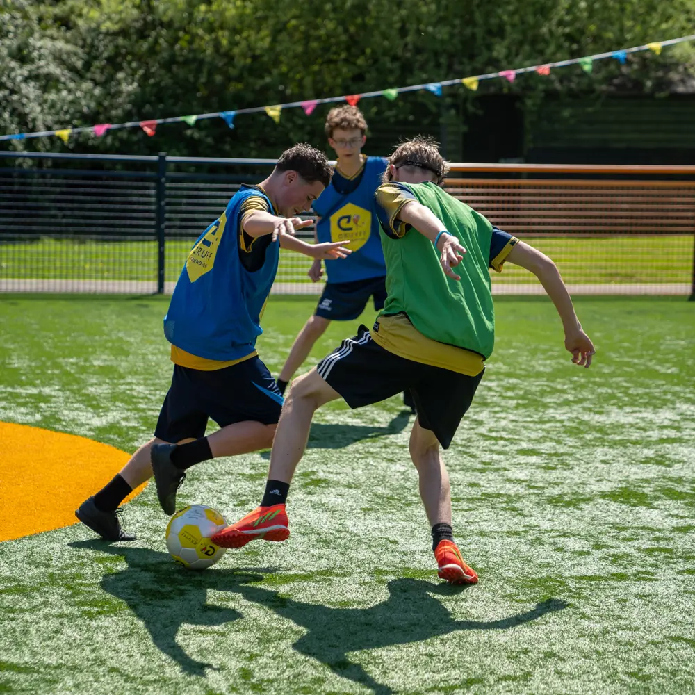 Pupils at Chilworth House Upper School playing football on the Cruyff court