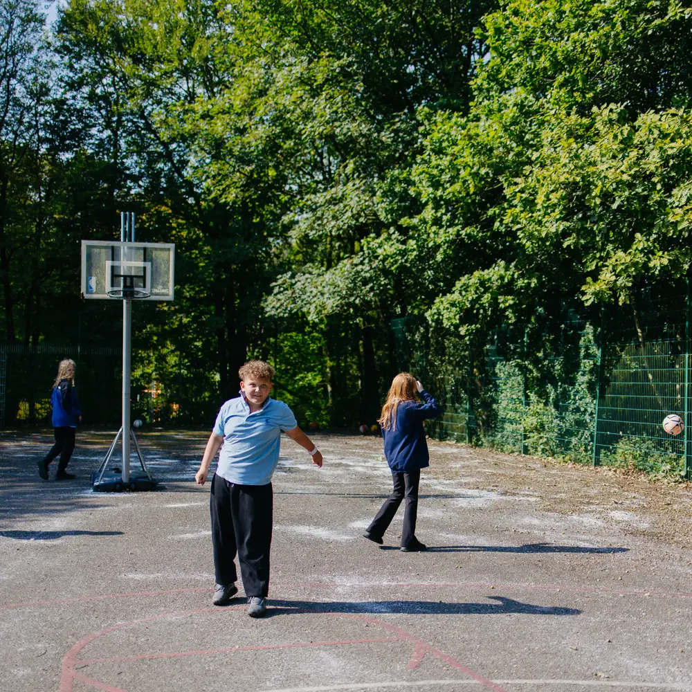 Pupils playing outside on the court yard at Cumberland School