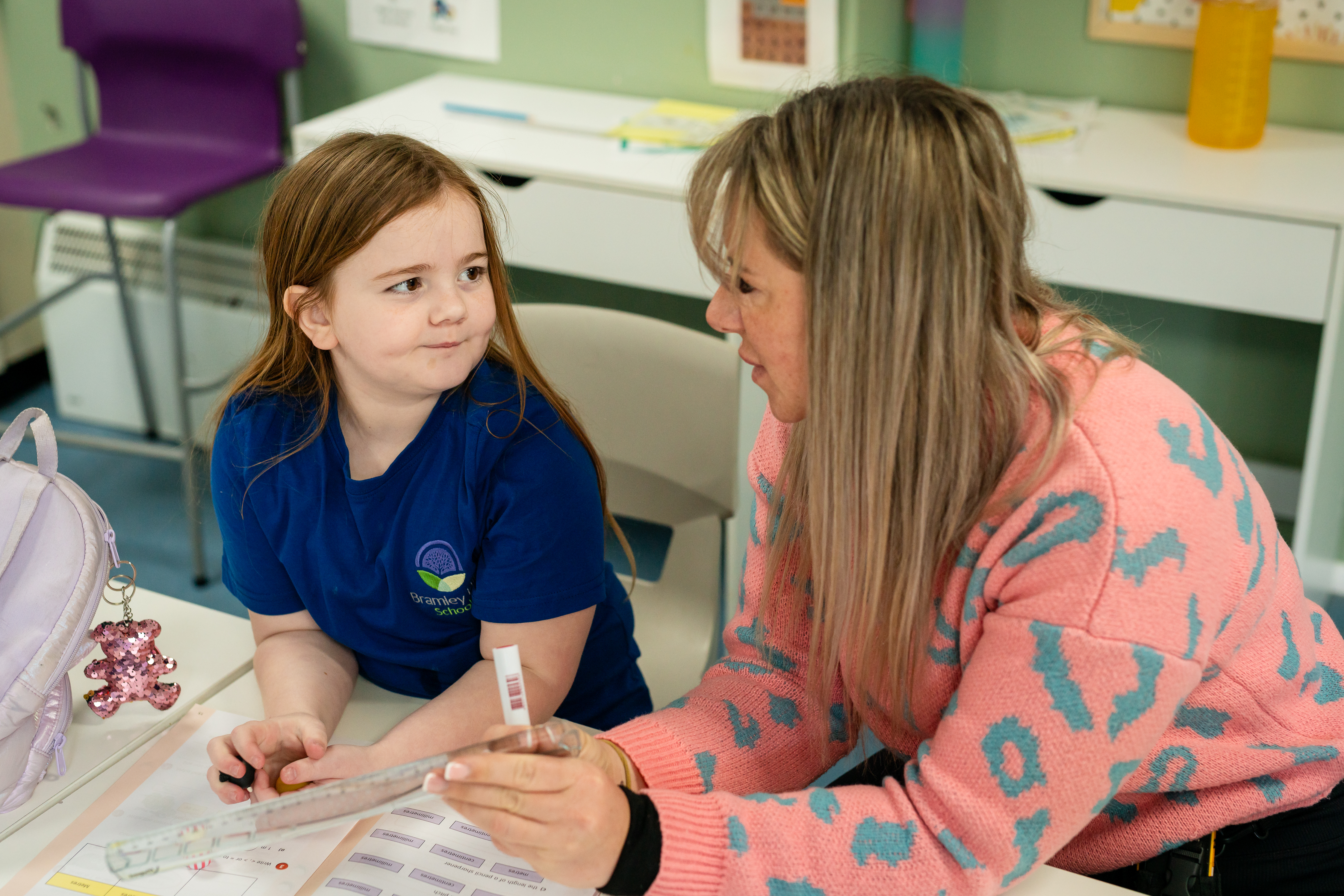 Young girl and teacher conversing