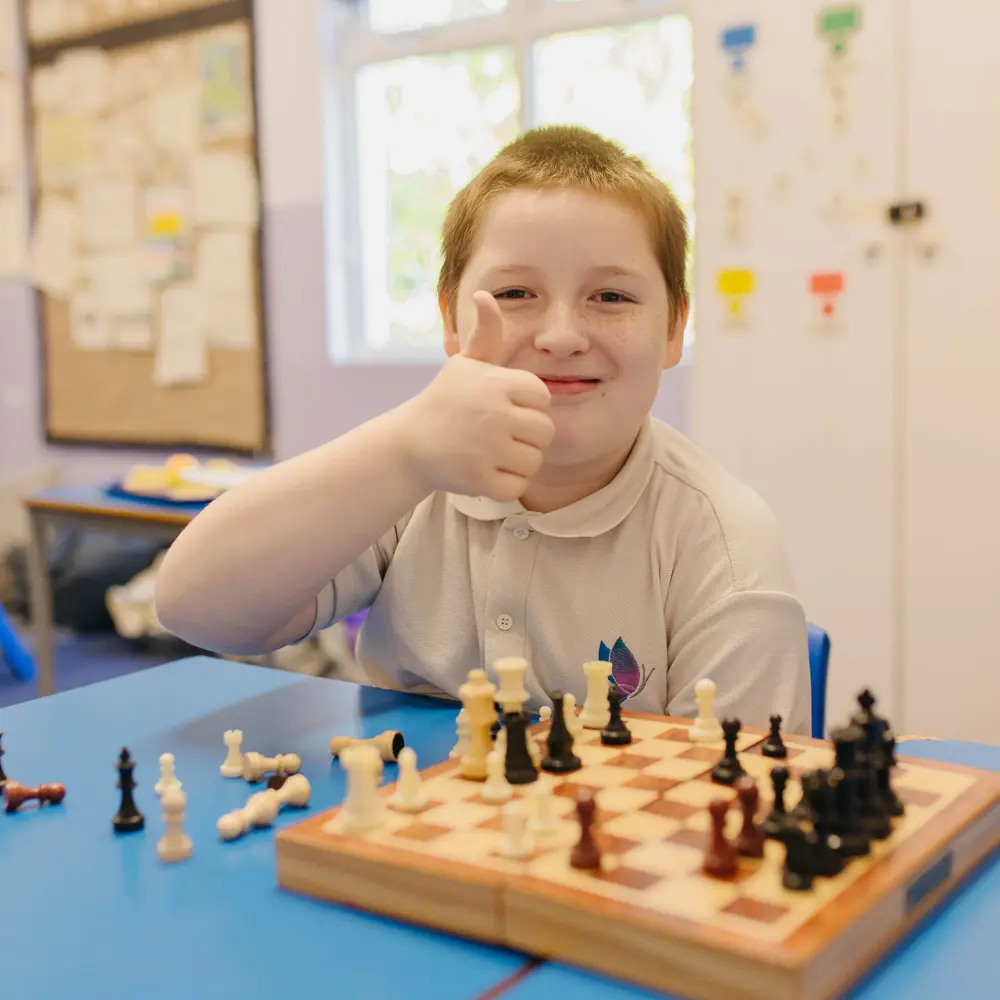 A young boy at Hall Cliffe Primary School playing chess