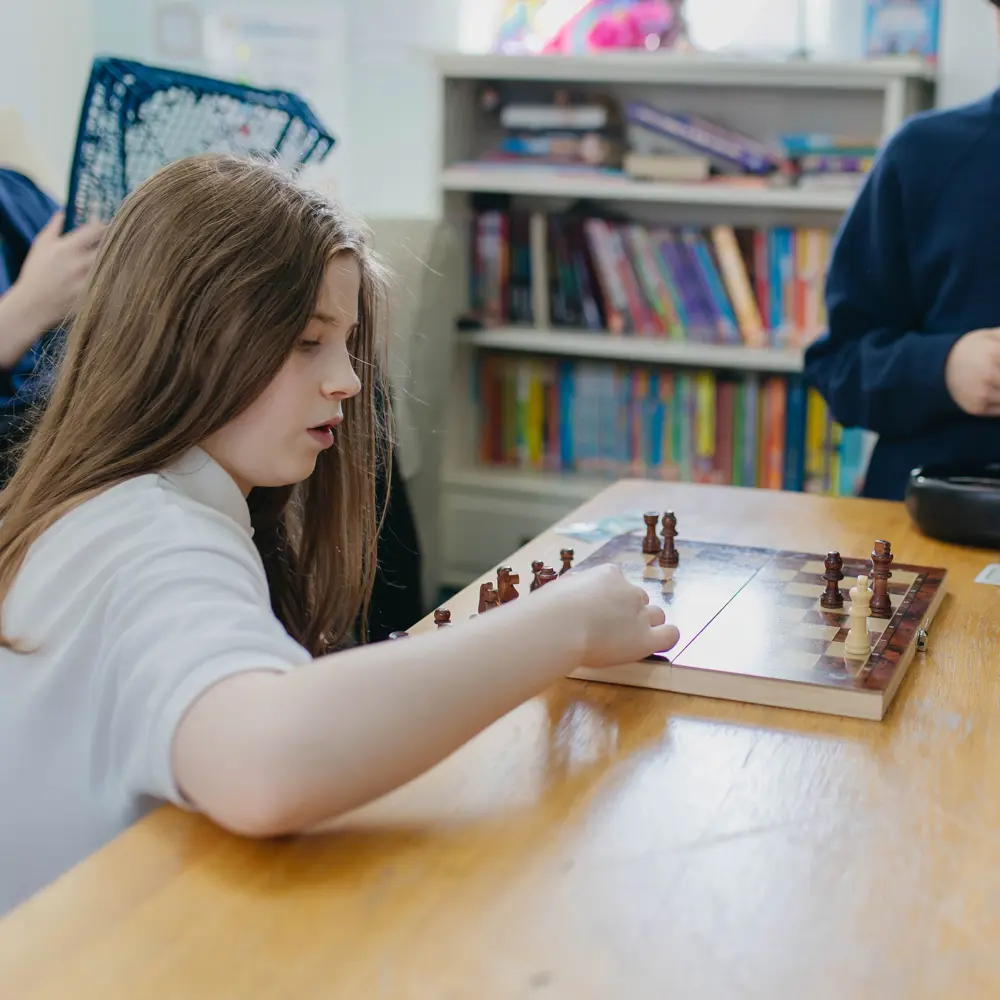 A young girl at Hall Cliffe School playing chess with another pupil