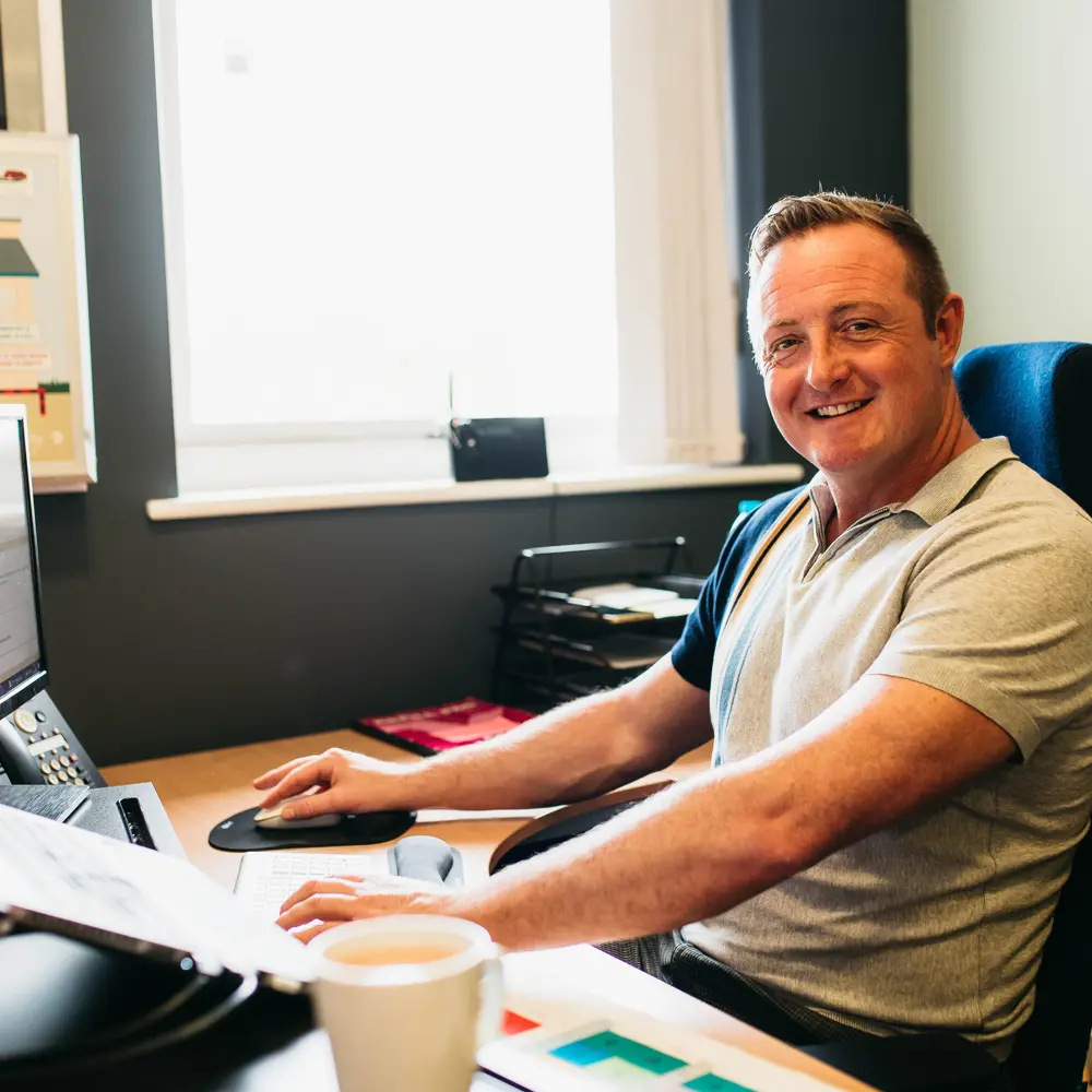 Headteacher of The Grange Learning Centre, Mark Boyle, sat at a computer