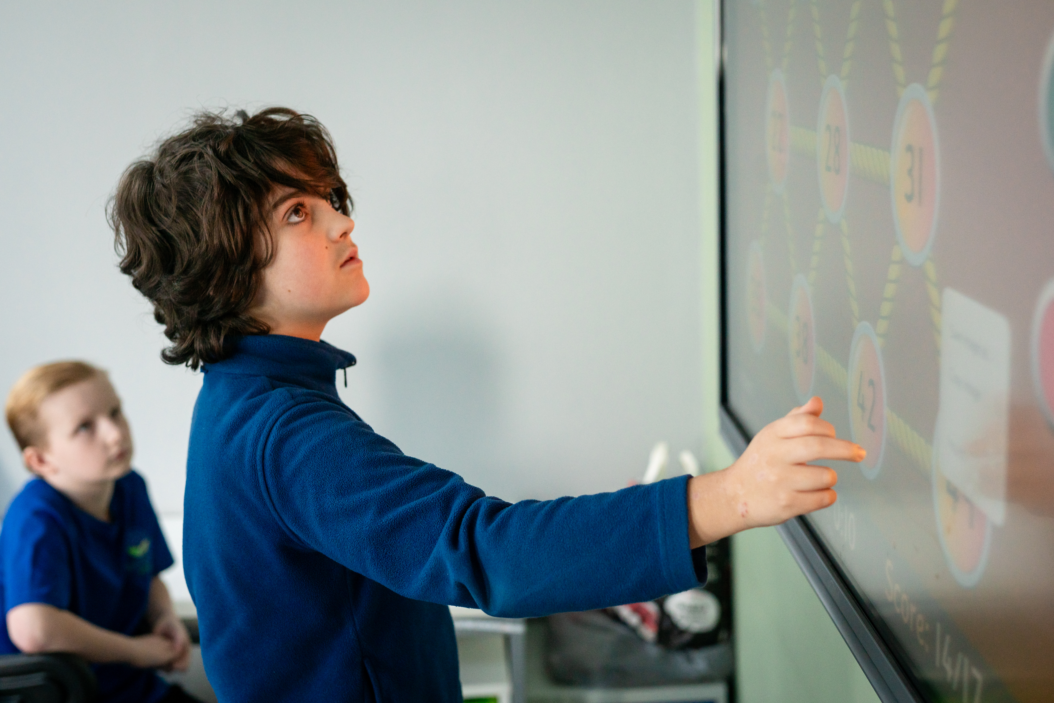 School boy learning on whitebaord