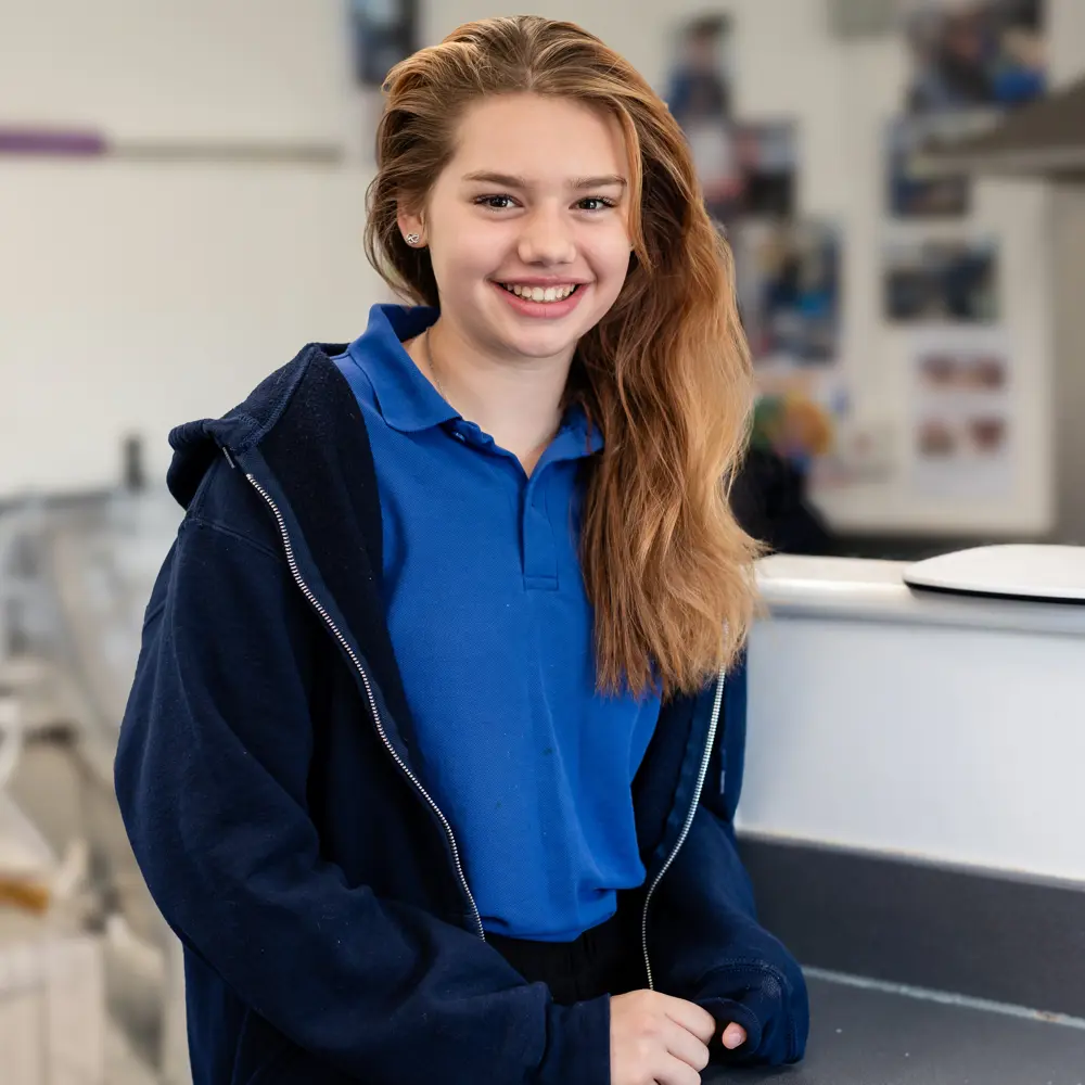 Girl from Chilworth House Upper School wearing blue shirt looking into the camera and smiling