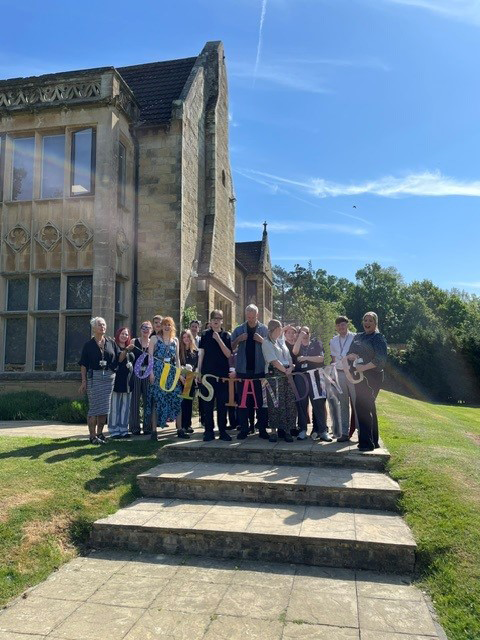 Staff members at Hilden Park School holding an outstanding sign for their Ofsted rating