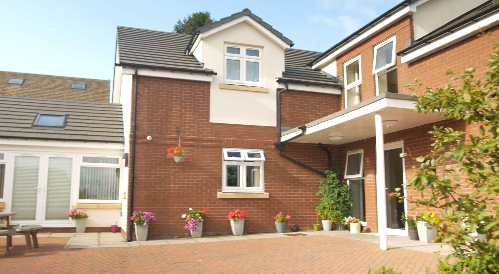 Beck View on a sunny day with potted flowers at the front