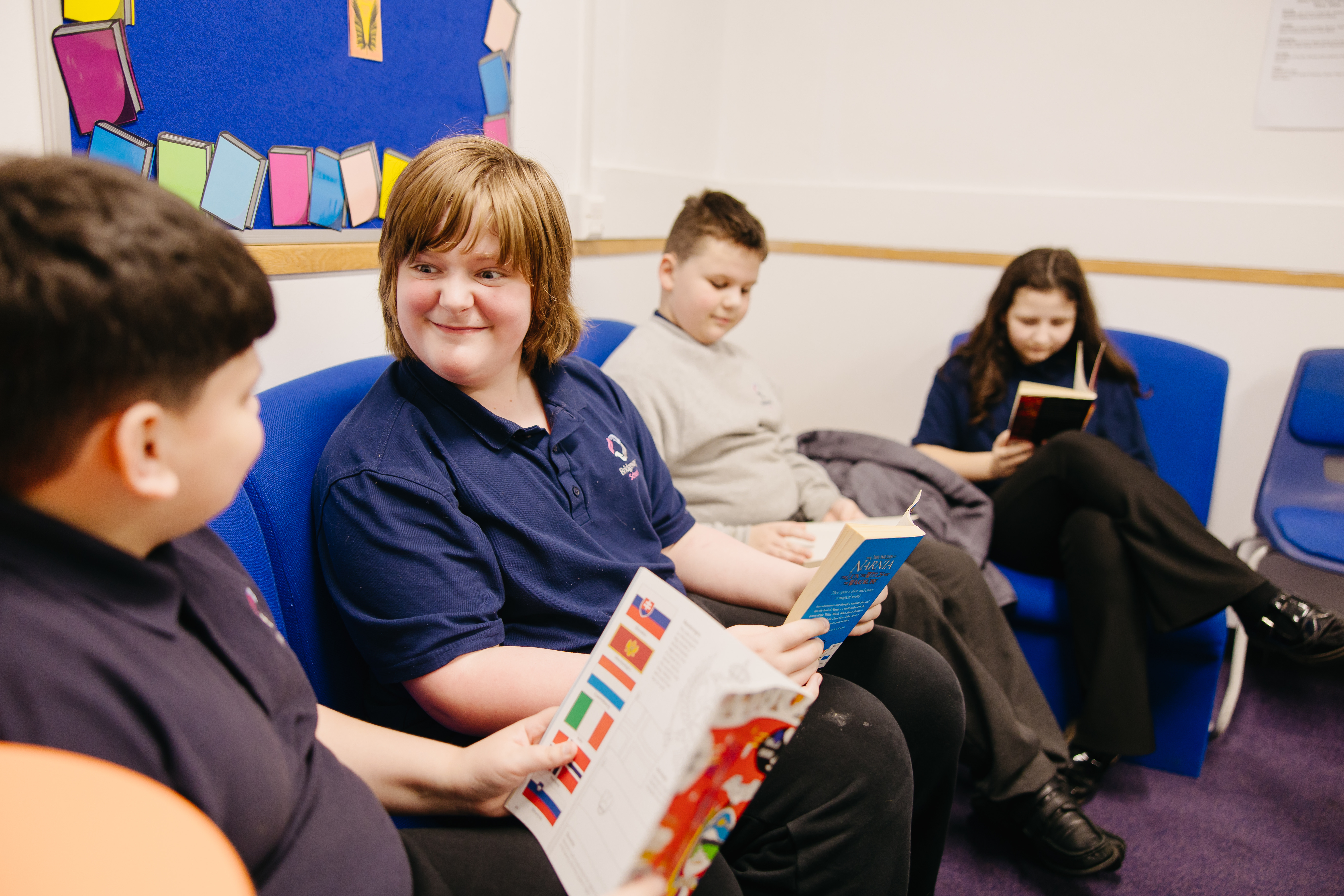 Four pupils sat in chairs reading
