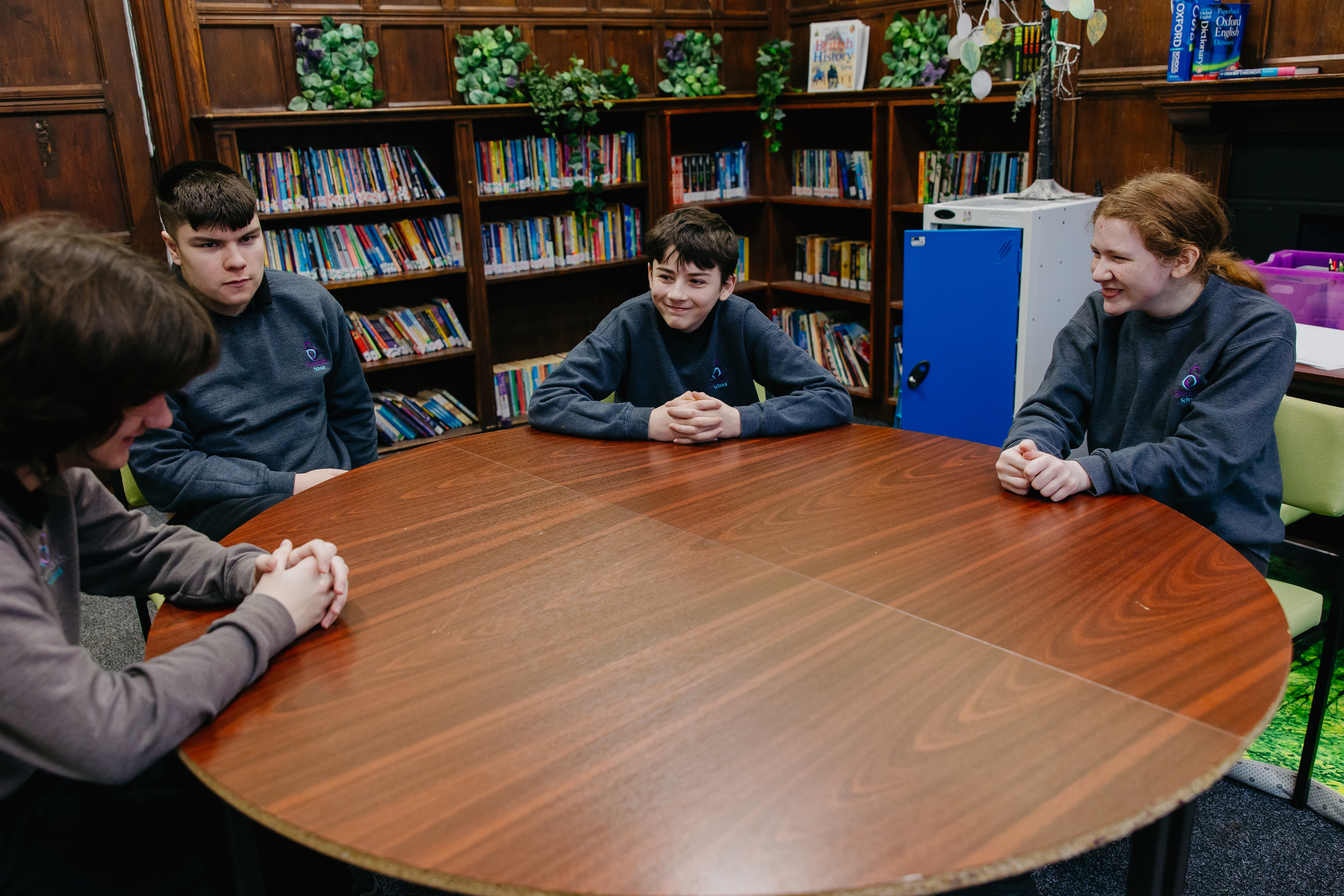 Four pupils sat round a table in the school library