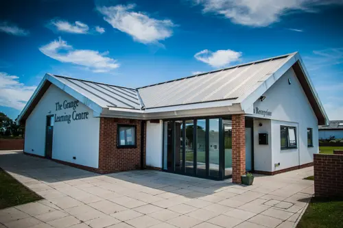 Outdoor photograph of The Grange Learning Centre on a sunny day