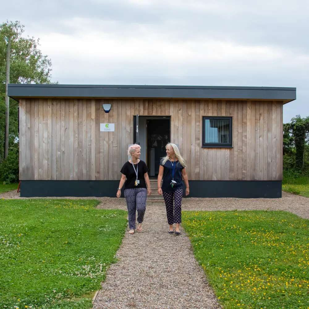 Two members of staff walking around out Elmbank Learning Centre