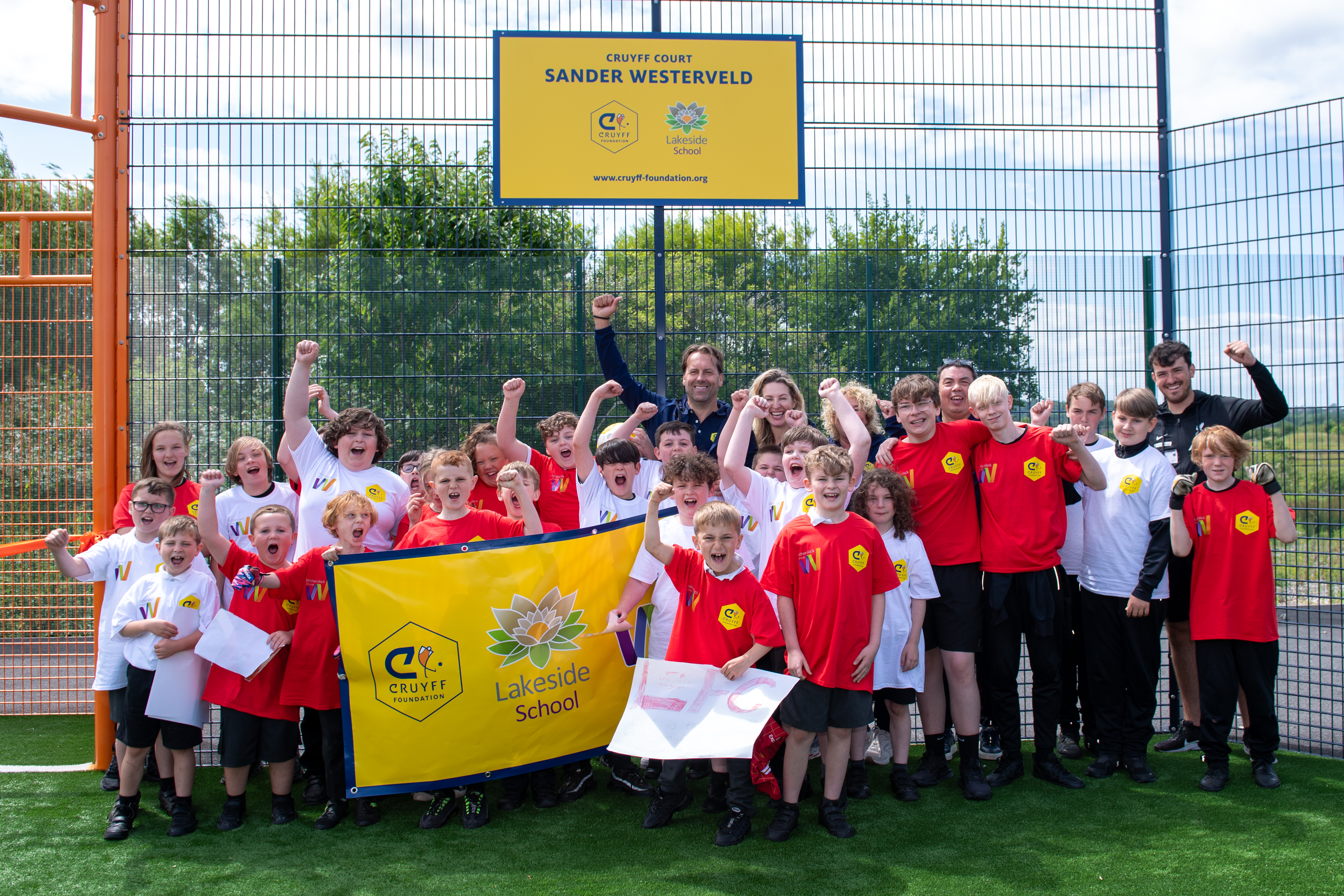 A group photo of pupils at Lakeside School cheering at the Cruyff Court Opening