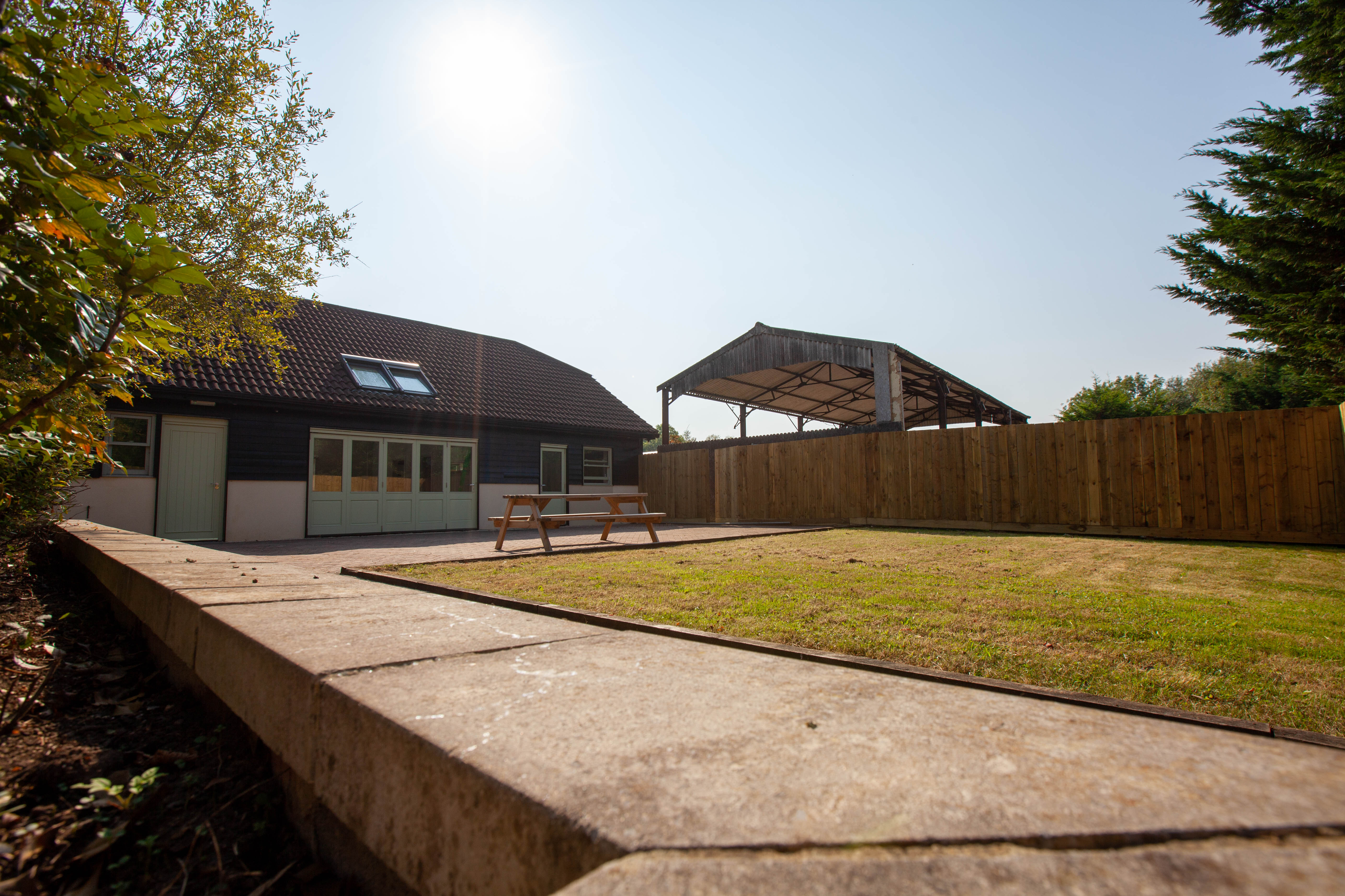 The back of Eavesfield Children's Home, showing the lawn and picnic bench