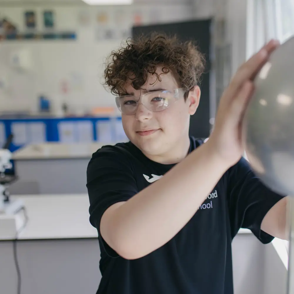 A young boy with brown hair from Abbeywood School in a science lesson