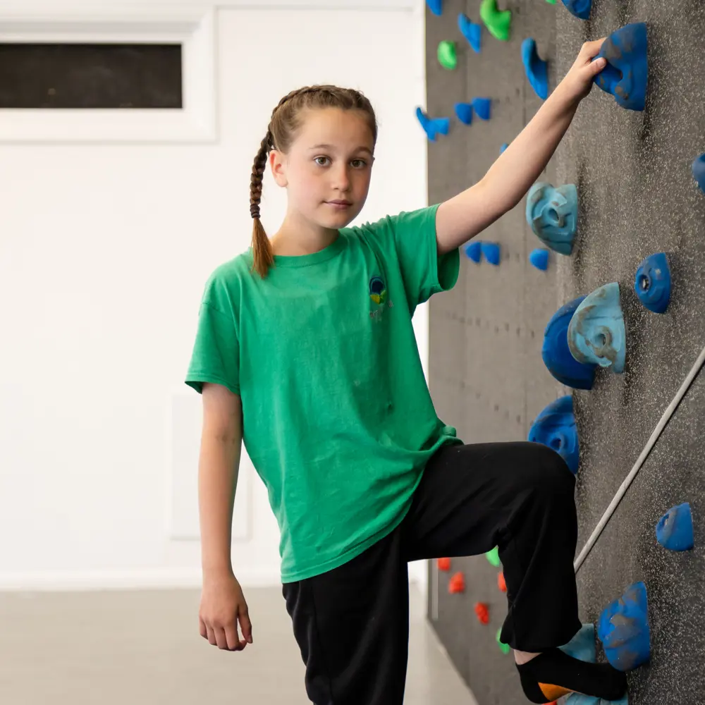 A young girl from Bramley Hill School using a climbing wall