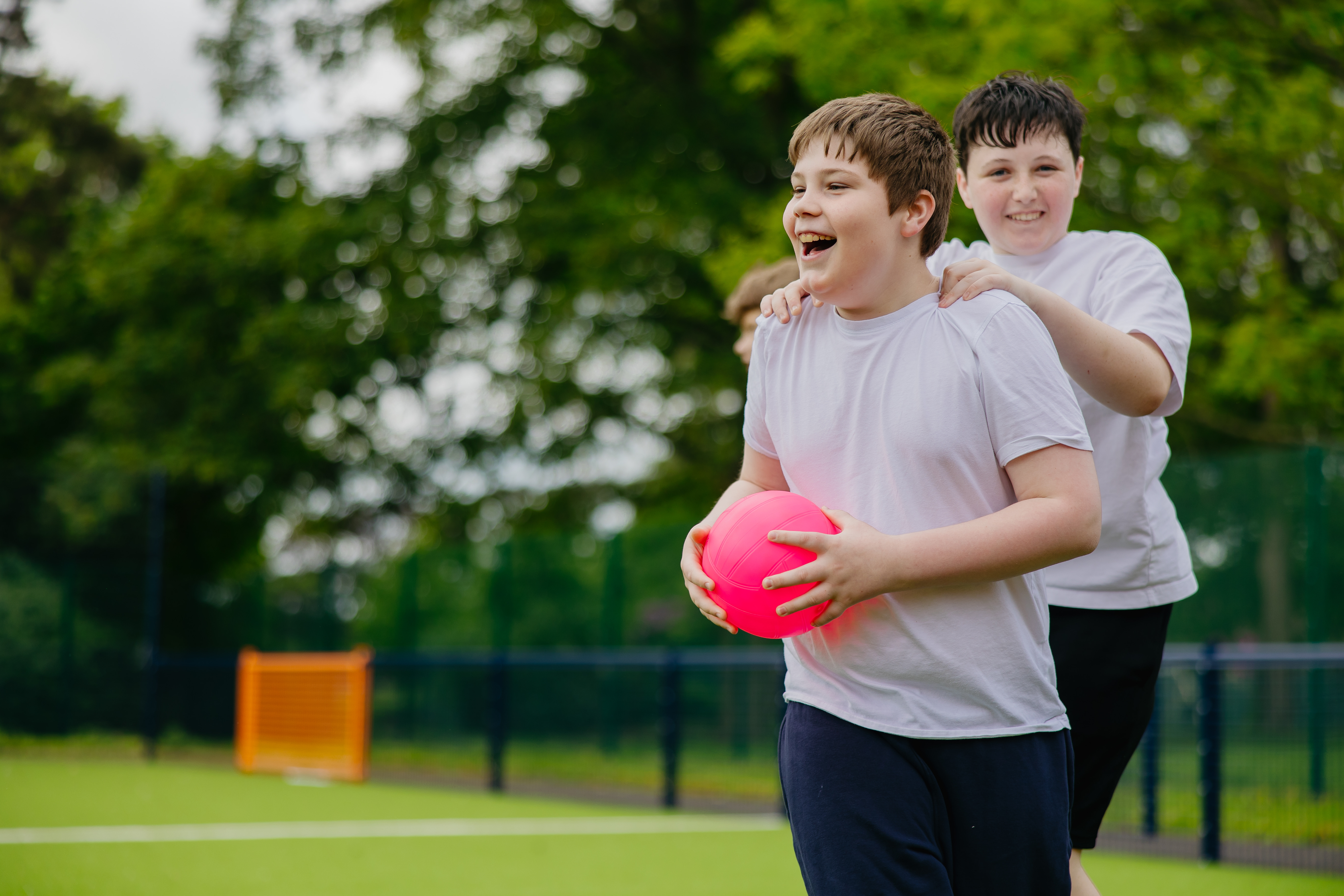 Two boys playing on sports court