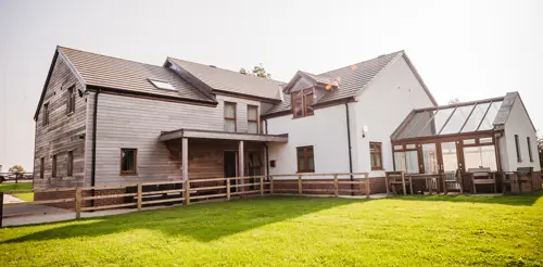 The outside of Grange View on a sunny day facing the conservatory