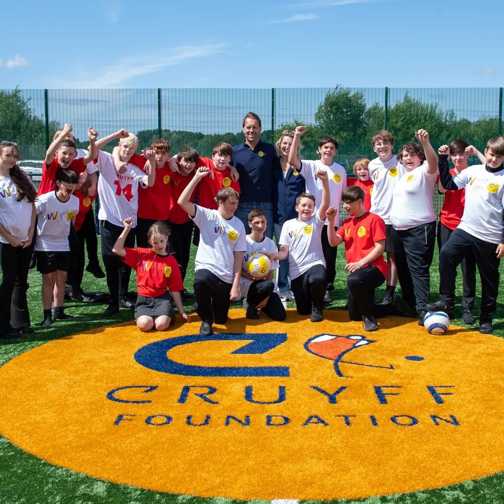 A group photo of the Cruyff Court opening at Lakeside School on a sunny day