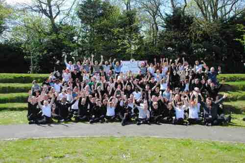 Whole school photograph of Ashbrooke School cheering for the Tes Awards